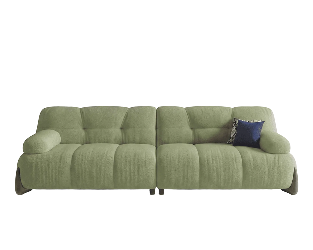 Green sofa with a blue pillow on a white background