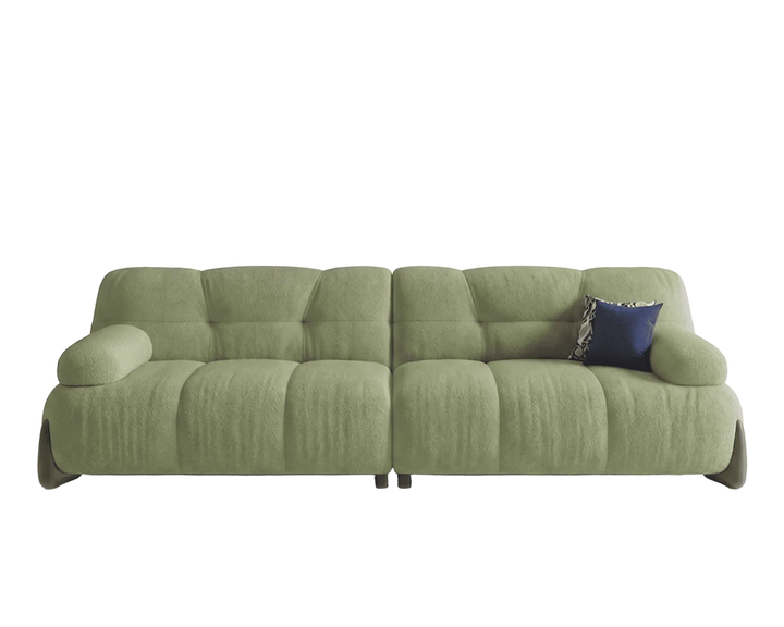 Green sofa with a blue pillow on a white background