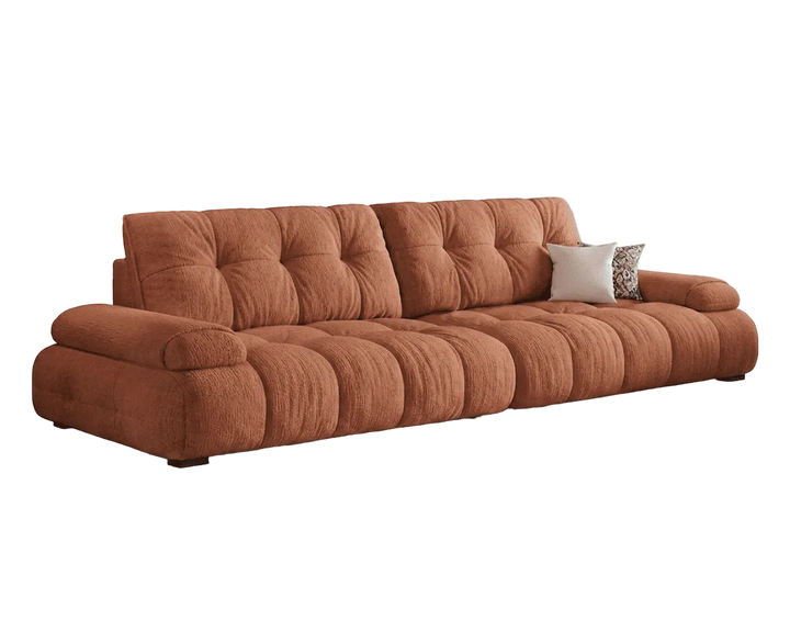 Brown sofa with tufted backrests on a white background