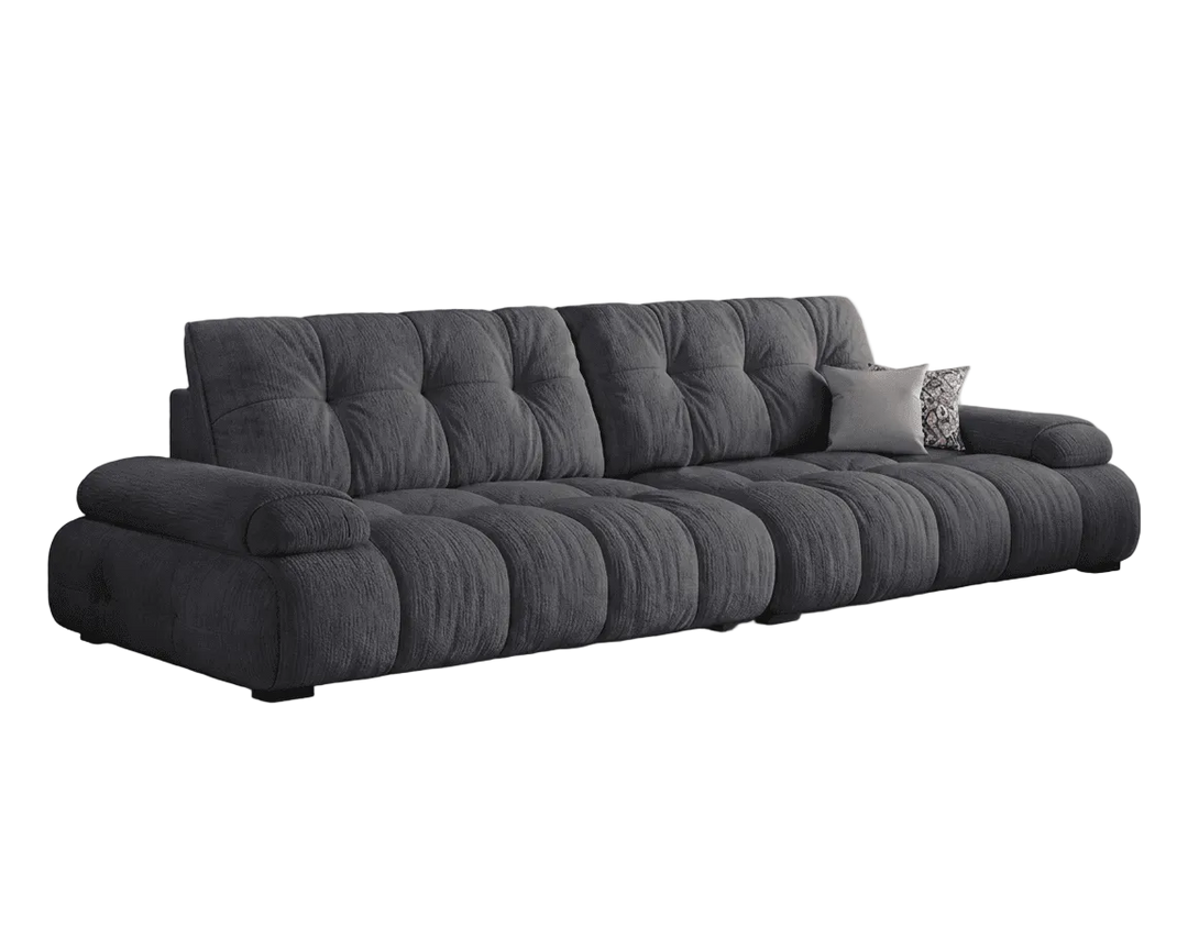 Gray sofa with tufted backrest on a white background