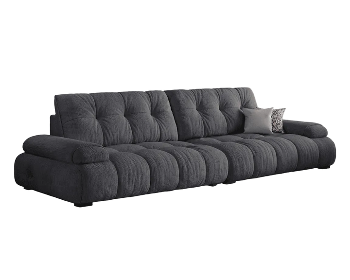 Gray sofa with tufted backrest on a white background