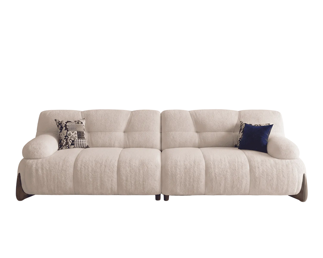 Beige sectional sofa with two cushions on a white background