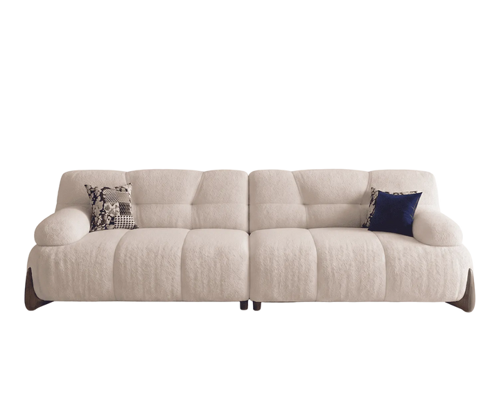 Beige sectional sofa with two cushions on a white background