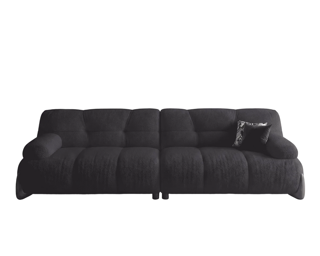 Black sofa with a pillow on a white background