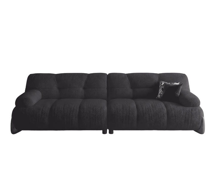 Black sofa with a pillow on a white background